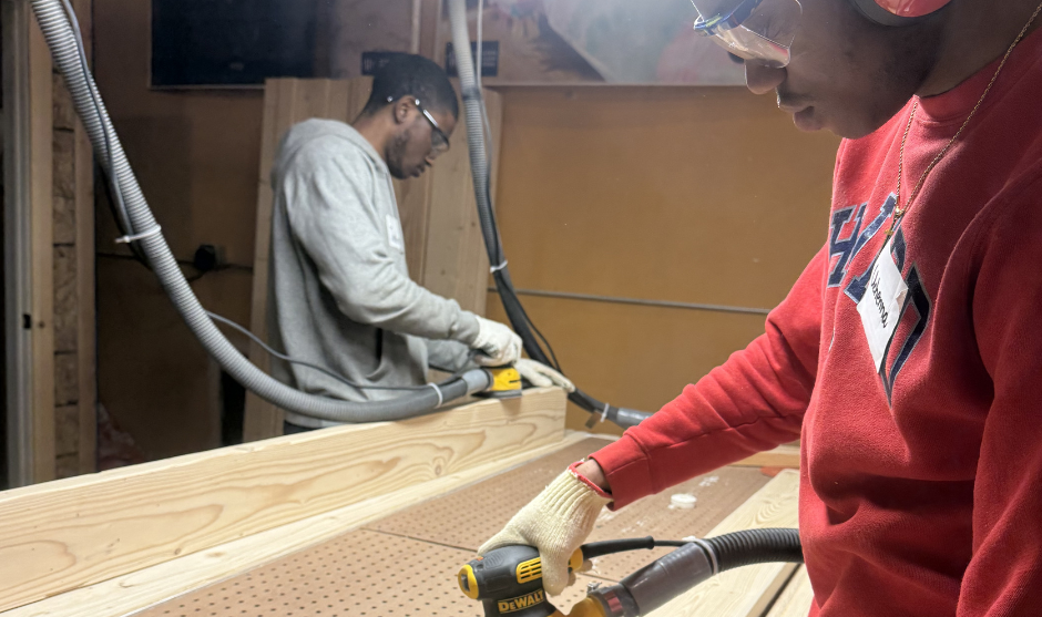 HUASB student sanding wood.