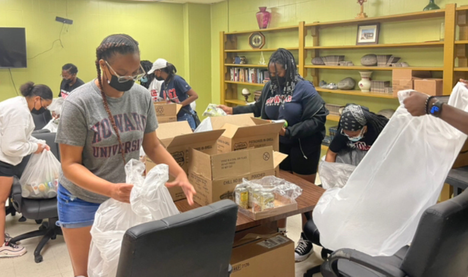 HUASB students serving and stuffing bags for the community