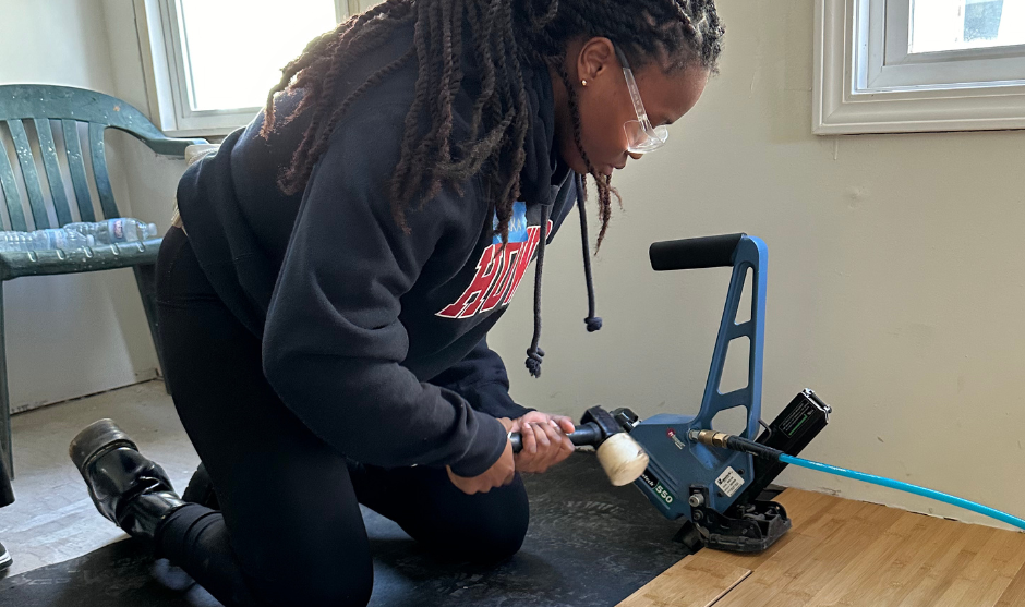 HUASB student doing flooring. 